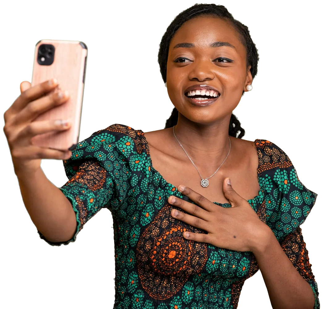 A smiling woman taking a selfie on her phone